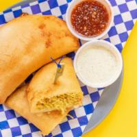 Chicken Criolla Empanadas · A deep fried sweet corn dough wraps the most delicious fillings.