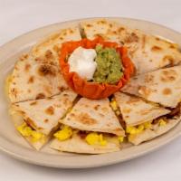 Breakfast Quesadilla · Our Famous Quesadilla made with Bacon and Egg and Cheese! Served with Guacamole and Sour Cream