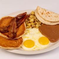 Breakfast Deluxe · Two eggs cooked any style, two buttermilk pancakes with hot syrup, two bacon, potatoes. refr...