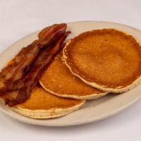 Pancakes With Bacon · Three buttermilk pancakes with hot syrup and two strips of the best bacon in town..