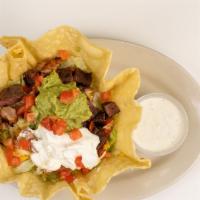 Combo Fajita Taco Salad · A bed of Lettuce topped with chicken and beef fajita meat, tomatoes, cheddar cheese, monterr...