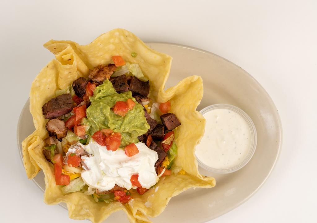 Combo Fajita Taco Salad · A bed of Lettuce topped with chicken and beef fajita meat, tomatoes, cheddar cheese, monterrey jack cheese, guacamole, and sour cream. Served with ranch dressing
