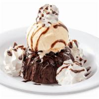 Molten Lava Cake · Chocolate Filled Cake, Topped with Hot Fudge and Served with Vanilla Ice Cream and Whipped C...