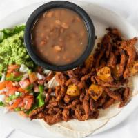 Tacos Al Pastor · Four tacos with chopped onions, cilantro and pineapple served with guacamole and frijoles de...