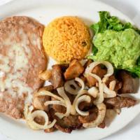 Carnitas · Served with French fries or refried beans, guacamole, Spanish rice, green onions and our spe...