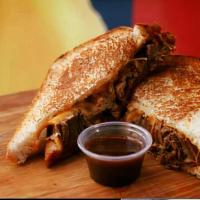 Brisket Grilled Cheese Sandwich · To buttery toasted slices, stuffed with melting cheddar cheese, and juicy smoked brisket.