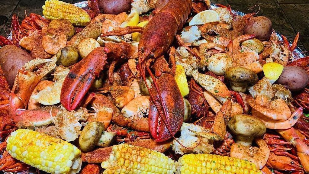 Ultimate Pot · 4 lbs crawfish, 1 lb boiled shrimp, pieces of king crab, snow crab, and Dungeness crab served with sausage, corn and potatoes, (smothered in G-style sauce).