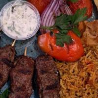 Seekh Kebab · Spicy kebab pieces paired with tzatziki sauce and a side of mixed vegetables.