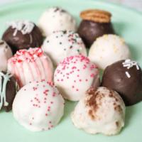 One Dozen Cake Balls  · The perfect bite-size ball of cake and icing rolled and dipped in chocolate and complemented...