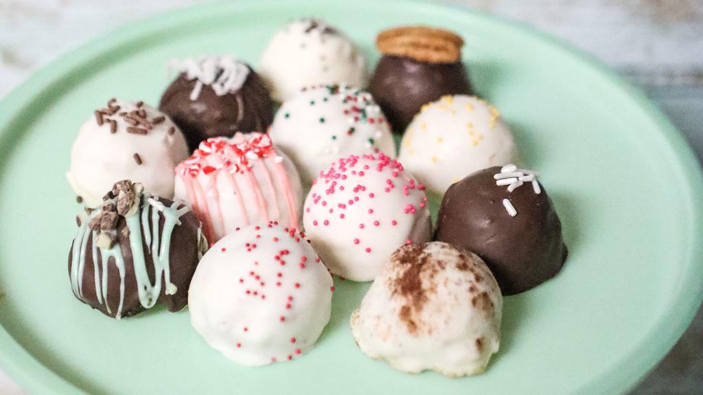 One Dozen Cake Balls  · The perfect bite-size ball of cake and icing rolled and dipped in chocolate and complemented with the perfect toppings.