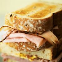 Urbano Sandwich · Tavern ham, blackened turkey, bacon, swiss, mayonnaise & yellow mustard