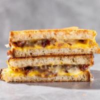The Favorite · Parmesan-crusted grilled sourdough with american, cheddar and gruyère cheeses, crumbled baco...