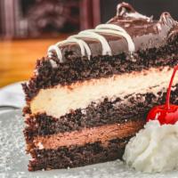 Tuxedo Cake · White and dark chocolate mousse between layers of moist chocolate cake covered in chocolate ...