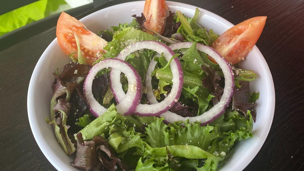 House Salad · Mixed greens, tomatoes, red onions. cucumbers and olives. Served with a side of our Homemade Tomato-Basil Vinaigrette