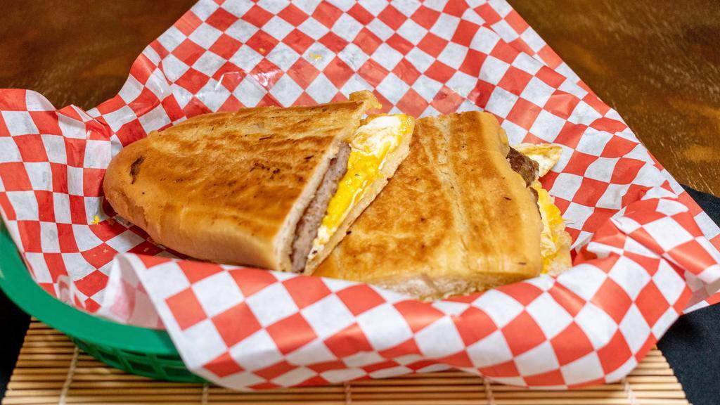Cuban Breakfast Sandwich · Three egg breakfast sandwich with American cheese, mayo, & your choice of bacon, sausage, ham, or turkey served on Cuban bread.