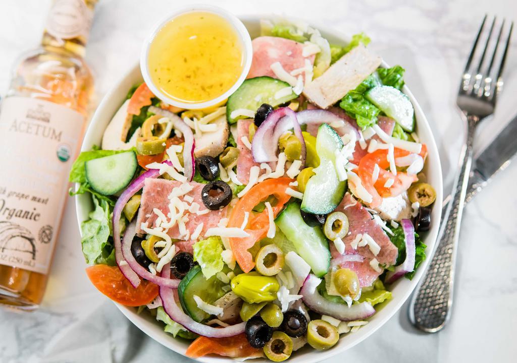 Chef Salad · Romaine lettuce, iceberg lettuce, mozzarella cheese, ham, chicken, fresh tomatoes, red onions, black olives, green olives, green peppers, cucumbers & pepperoncini peppers.