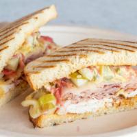 Cubano · Sliced turkey, ham, Swiss cheese, sliced dill pickles with our special house-made pickled re...