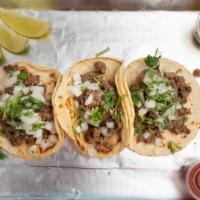 Street Tacos (Three Taco) · Soft corn or flour tortillas topped with onion & cilantro.