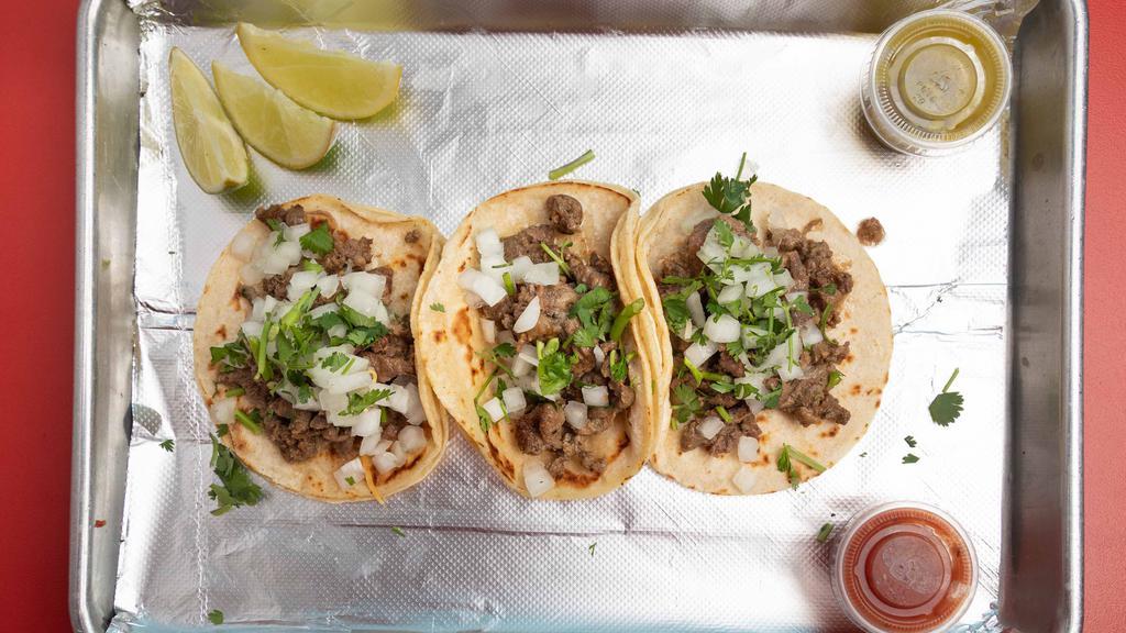 Street Tacos (Three Taco) · Soft corn or flour tortillas topped with onion & cilantro.
