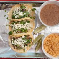 Street Tacos (Single Taco) · Soft corn or flour tortillas topped with onion & cilantro.