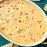 Chile Con Queso · Cheddar melted cheese with jalapeno pepper, tomato, and cilantro. Served with chips.