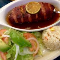 Filete Relleno A La Plancha · Tilapia fillet filled with octopus and shrimp, wrapped with bacon, topped with a butter pars...