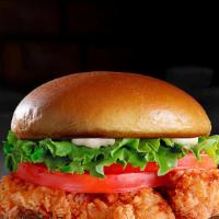 Crispy Chicken Sandwich · Hand-breaded chicken breast served with lettuce, tomato, mayo and pickles.