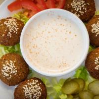 Falafel · Rolled with tomatoes, lettuce, pickles, parsley, and tahini sauce.