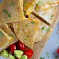 Mini Quesadillas · Corn tortillas filled with blended Mexican cheese, sour cream, guacamole, chili de arbor sal...