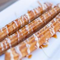  Churros · Deep-fried fritter rolled in cinnamon sugar, served with caramel, whipped cream, and vanilla...