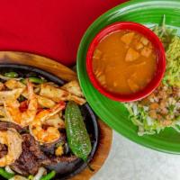 Parillada Compadres · Beef and chicken fajita, sausage and shrimp, served with grilled onion and bell pepper.