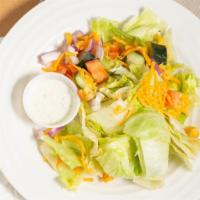 House Salad · Mixed greens, market tomatoes, red onions, shredded cheddar, and cucumber with dressing.