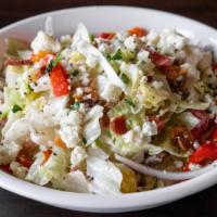 Chopped Wedge · Iceberg, bacon, tomatoes, red onion, roasted peppers, and gorgonzola dressing.