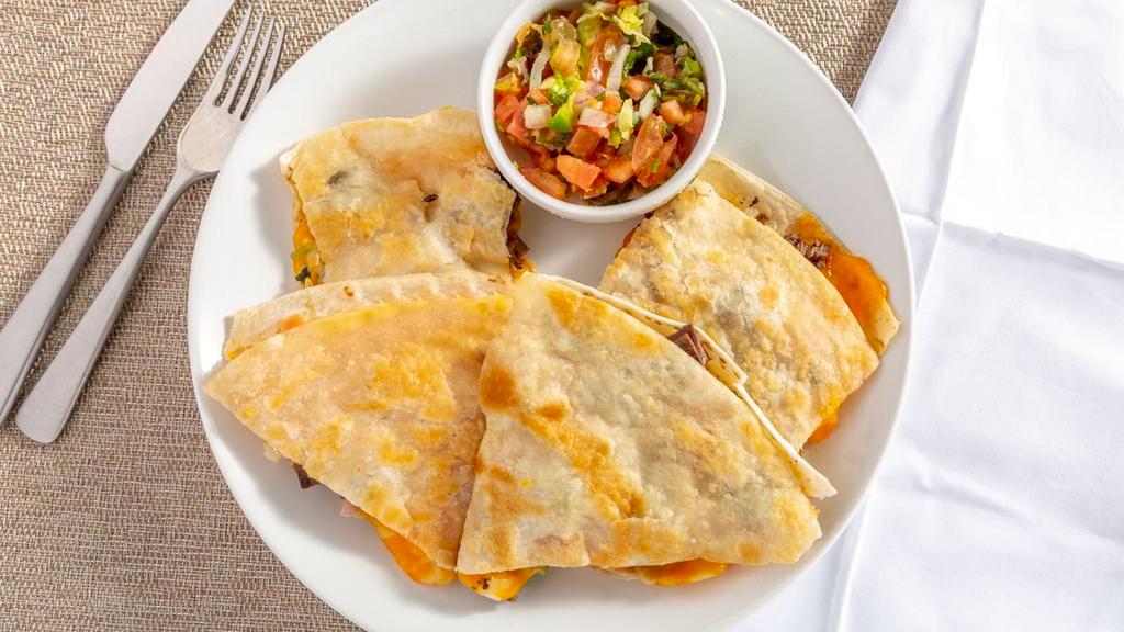 Quesadillas · Freshly pressed flour tortilla filled with your choice of beef or chicken fajita served with pico de gallo, guacamole and sour cream.