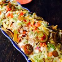Nacho Libre · Freshly made chips topped with refried beans, queso loco, lettuce, pico de gallo, cheddar ch...