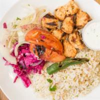Chicken Shish Kebab (Chicken Breast) · Grilled cubes of marinated chicken, served on a bed of rice.