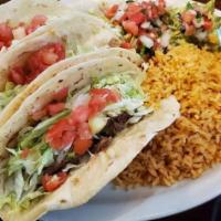 Brisket Tacos · Three soft corn tortillas filled with brisket, melted jack cheese, lettuce and tomatoes. Ser...