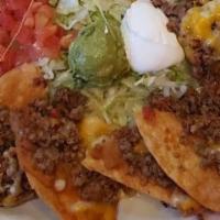 Chicken Nachos De Fajita · Individual corn tortilla chips topped with beans, chicken fajitas with cheese. Served with s...
