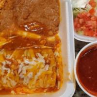 Beef Burrito · Ground beef burrito topped with enchilada sauce and cheese. Served with shredded lettuce. So...