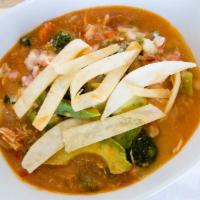 Tortilla Soup · Topped with tortilla strips, a slice of avocado and grated cheese.