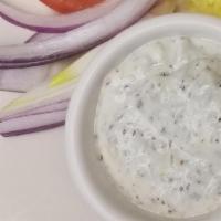 Tzatziki Appetizer · Greek yogurt, cucumber with herbs and garlic served with pita bread.