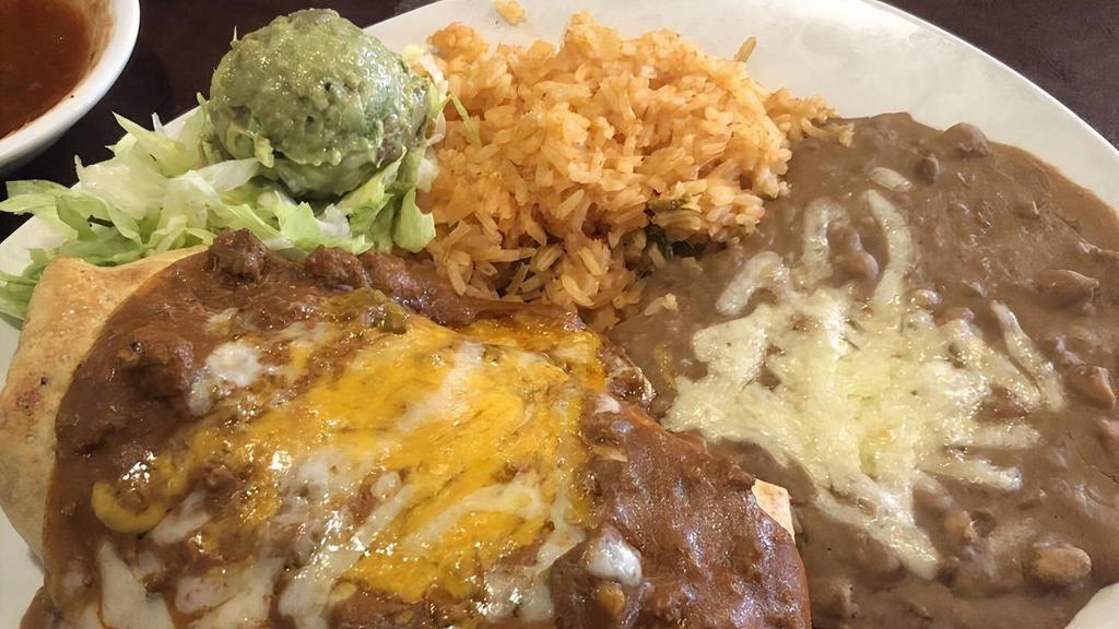 Chimichanga A Mucho Grande · Flour tortilla stuffed with chicken or beef, cheese, and beans, deep fried, topped with ranchero sauce, served with guacamole, salad, rice, and beans.