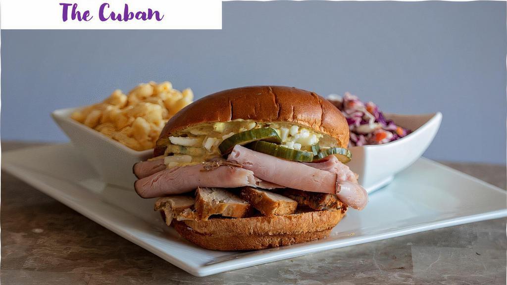 The Cuban · Pulled Pork with Ham, Swiss, House Made Pickles and Our Famous Cuban Sauce