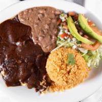 Mole Mexicano · Boneless chicken with mole sauce, served with rice, beans, and salad.