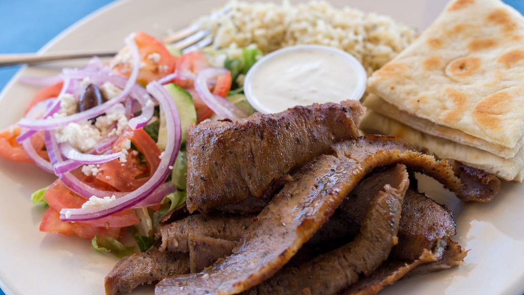 Gyro Skillet · Fajita style! Served with sautéed onions, green peppers tomatoes and rice or fries and a mini Athenian salad.