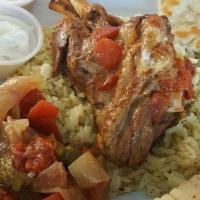 Lamb Shank Dinner · Oven roasted Lamb Shank served with rice small salad tzatziki and pita bread!