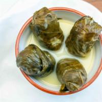 Meat Dolmas (4) · Stuffed grape leaves with a meat and rice mixture and lemon sauce.