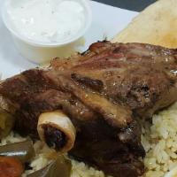 Lamb Shank Plate. · Oven roasted Lamb Shank served with rice small salad tzatziki and pita bread!