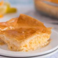Galaktoboureko · Phyllo stuffed with custard and topped with our syrup.