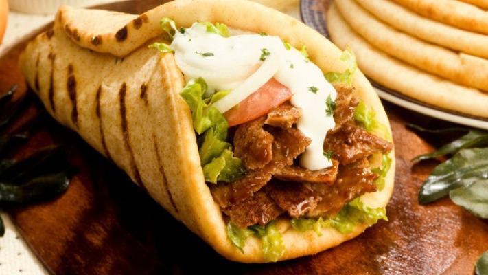 Beef Shawarma Wrap · Beef Shawarma with tomatoes, onion and lettuce on pita bread. Pick your sauces.